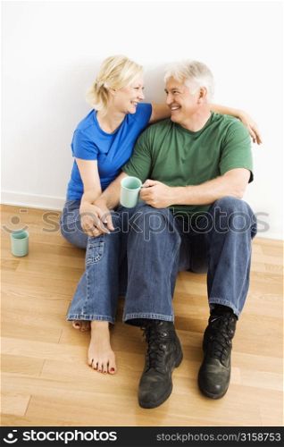 Older couple smiling and drinking tea