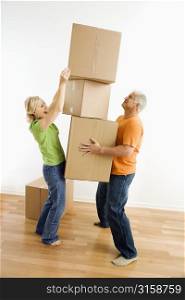 Older couple stacking boxes