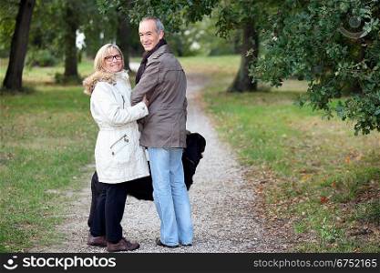 Older couple strolling through a park