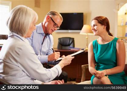 Older Couple Talking To Financial Advisor In Office