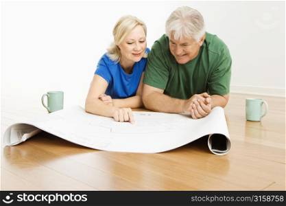 Older couple with house plans