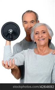 Older couple working out with weights