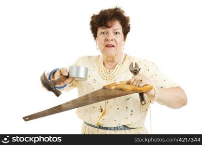 Older lady holding tools. She is confused and overwhelmed by home improvement project. Isolated on white.