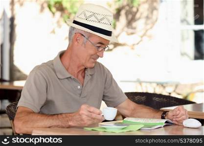 Older man at an alfresco cafe