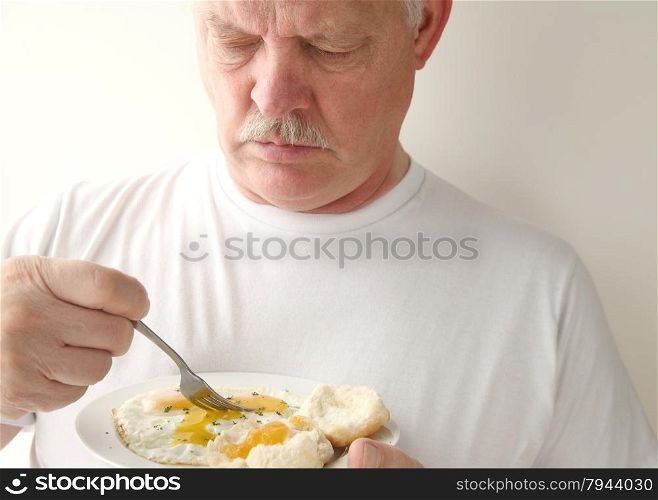 older man eating his breakfast