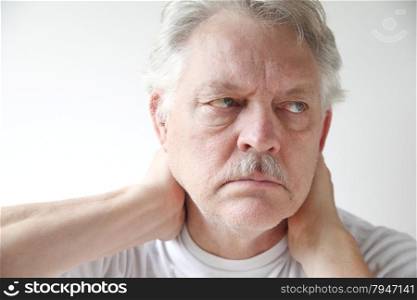 Older man experiences soreness in his neck.