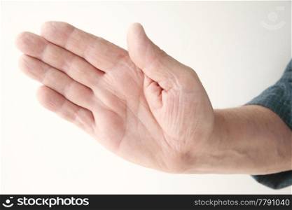 older man holding a hand out at an angle