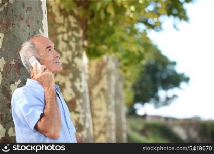Older man outdoors with a cellphone
