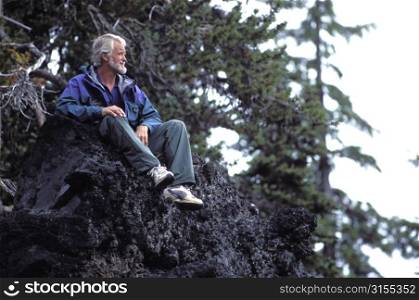 Older Man Sitting on a Rock