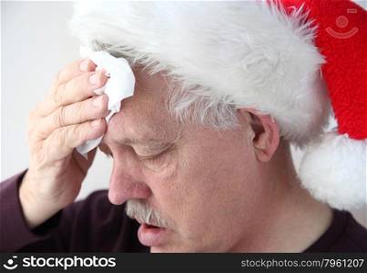 older man sweats under either physical or mental holiday stress