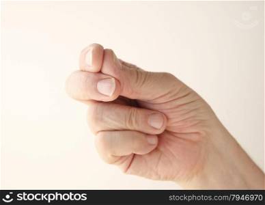 Older man uses a gesture of finger snapping.