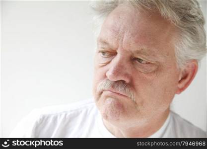 older man with a negative, disgruntled expression
