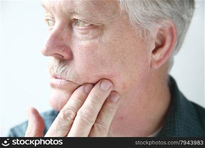older man with a red, itchy rash on his cheek