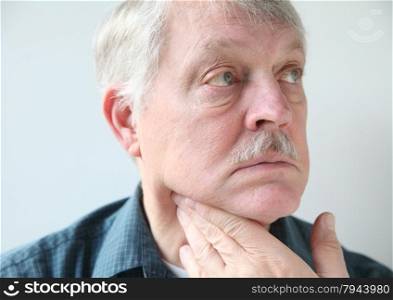 older man with a sore throat or neck