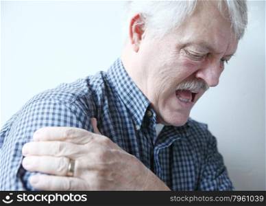 older man with pain in his shoulder