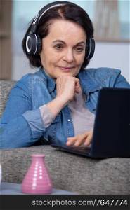 older mature woman using wireless laptop