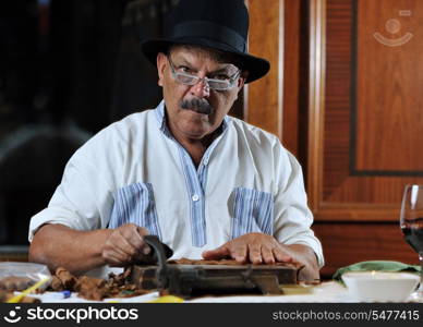 older senior man making luxury handmade cuban cigare