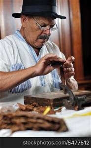 older senior man making luxury handmade cuban cigare