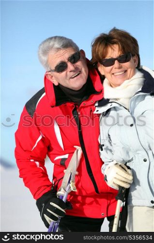 Older ski couple on a mountain