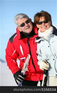Older ski couple on a mountain