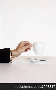 Older woman&acute;s hand holding cup