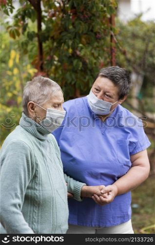 older woman being taken care by female nurse