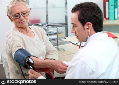 Older woman having her blood pressure taken