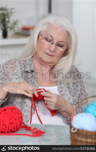 Older woman knitting
