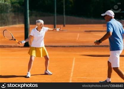 Older Woman Practicing Tennis with Instructor