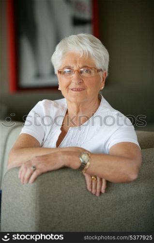 Older woman sitting on a sofa