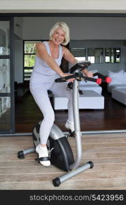 Older woman using an exercise bike