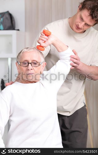 Older woman working out with a personal trainer