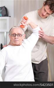 Older woman working out with a personal trainer