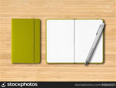 Olive green closed and open lined notebooks with a pen. Mockup isolated on wooden background. Olive green closed and open lined notebooks with a pen on wooden background