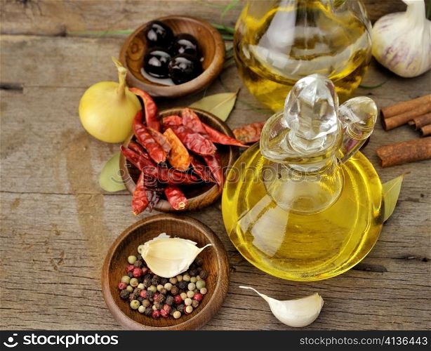 Olive Oil And Spices On Wooden Background