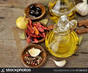 Olive Oil And Spices On Wooden Background