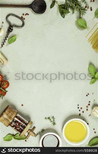 Olive oil, balsamic vinegar, salt, pepper, herbs, pasta, tomatoes on concrete background - cooking ingredients background -- top view - space for text. Healthy food, vegetarian or italian food concept.. Olive oil, balsamic vinegar, salt, pepper, herbs, pasta, tomatoes on concrete background