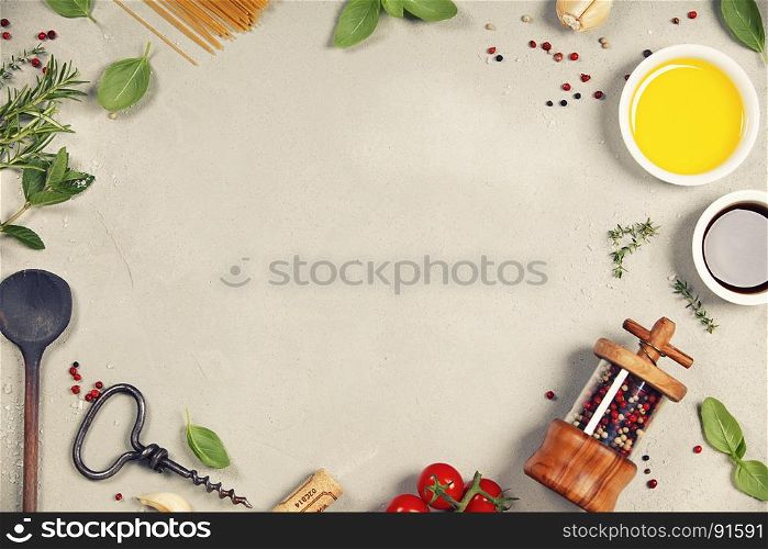 Olive oil, balsamic vinegar, salt, pepper, herbs, pasta, tomatoes on concrete background - cooking ingredients background -- top view - space for text. Healthy food, vegetarian or italian food concept.
