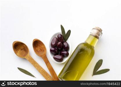 olive oil bottle purple olives wooden spoons. High resolution photo. olive oil bottle purple olives wooden spoons. High quality photo