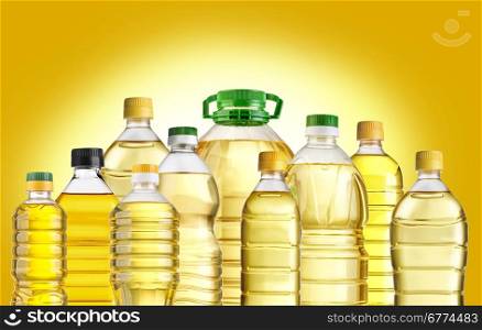 Olive oil bottles isolated on yellow background