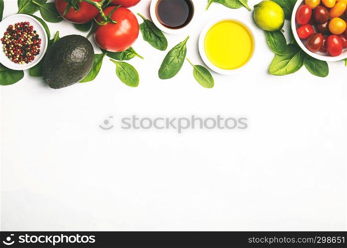 Olive oil, vinegar, vegetables and spices on white stone background. Making salad, cooking, clean eating, dieting concept. Flat lay. Fresh vegetables background, flat lay, top view
