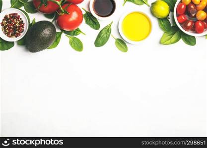 Olive oil, vinegar, vegetables and spices on white stone background. Making salad, cooking, clean eating, dieting concept. Flat lay. Fresh vegetables background, flat lay, top view