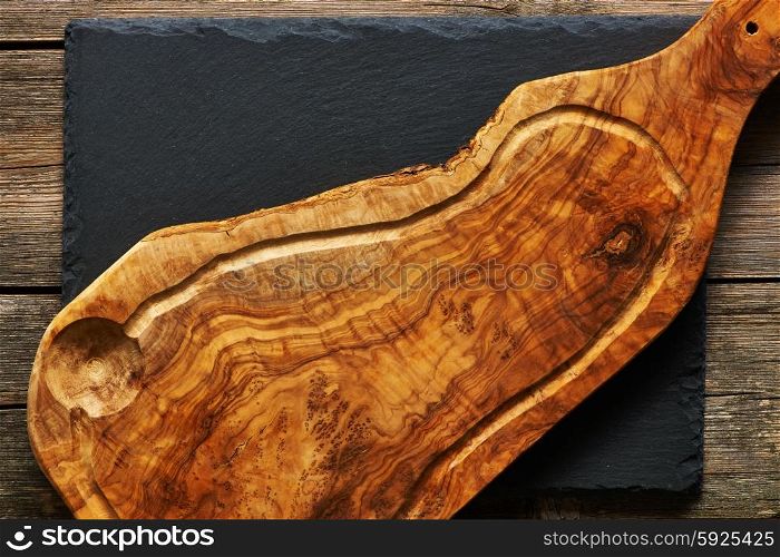 Olive wood cutting board over slate