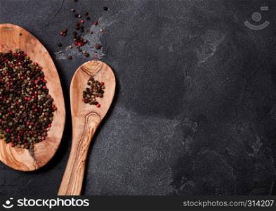Olive wood kitchen utensils with bowl on stone table background. Top view.