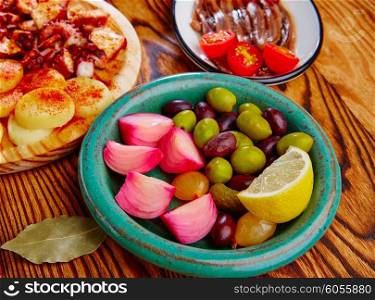 Olives and onion pickles tapas with anchovies and octopus gallega
