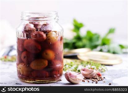 olives in bank and on a table
