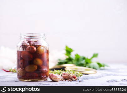 olives in bank and on a table