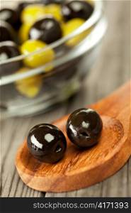 Olives on a wooden table ...