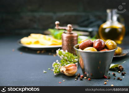 olives with spice in metal bowl and on a table