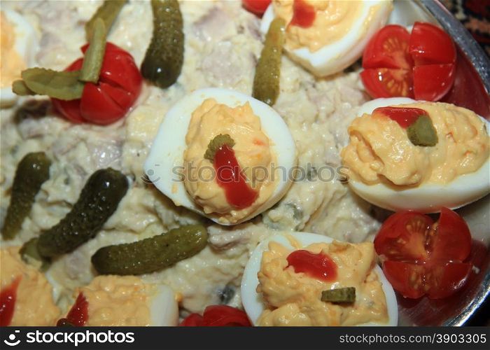 Olivier salad with stuffed eggs and pickles